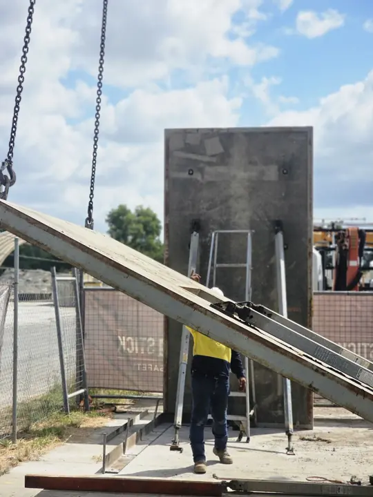Precast panel on chains during a tilt-up lift